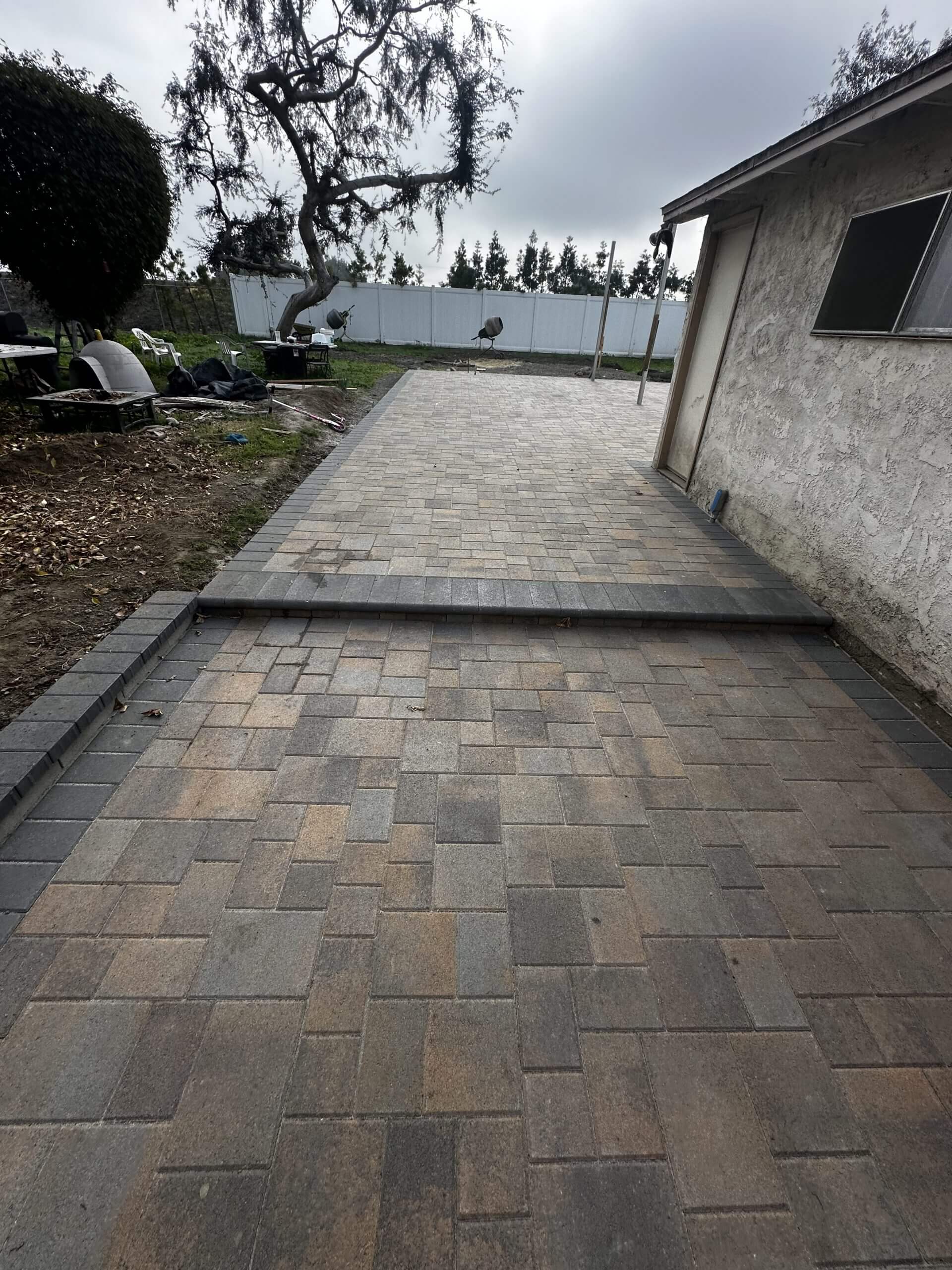 Paver walkway and patio along the side yard