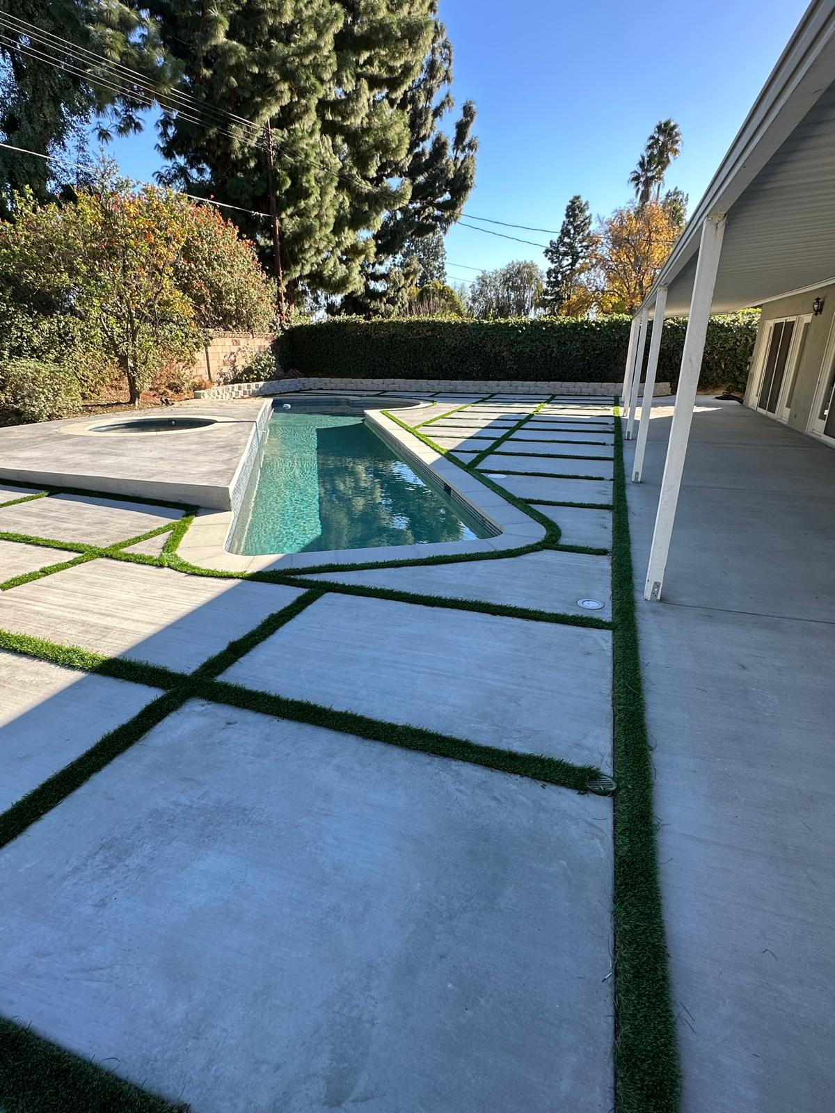 Lap pool with concrete-and-turf checkerboard decking