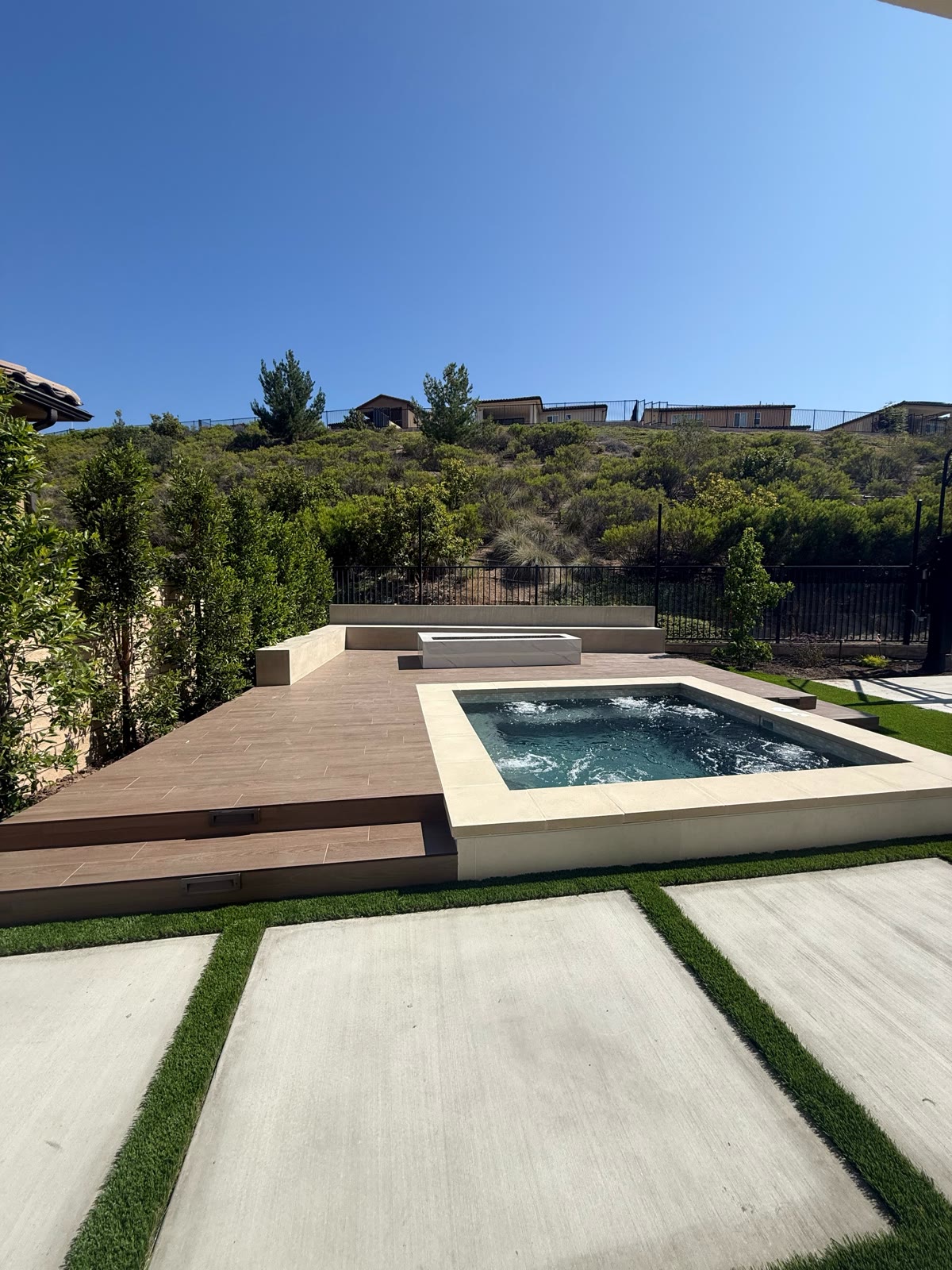 Raised spa and wood deck overlooking a natural hillside