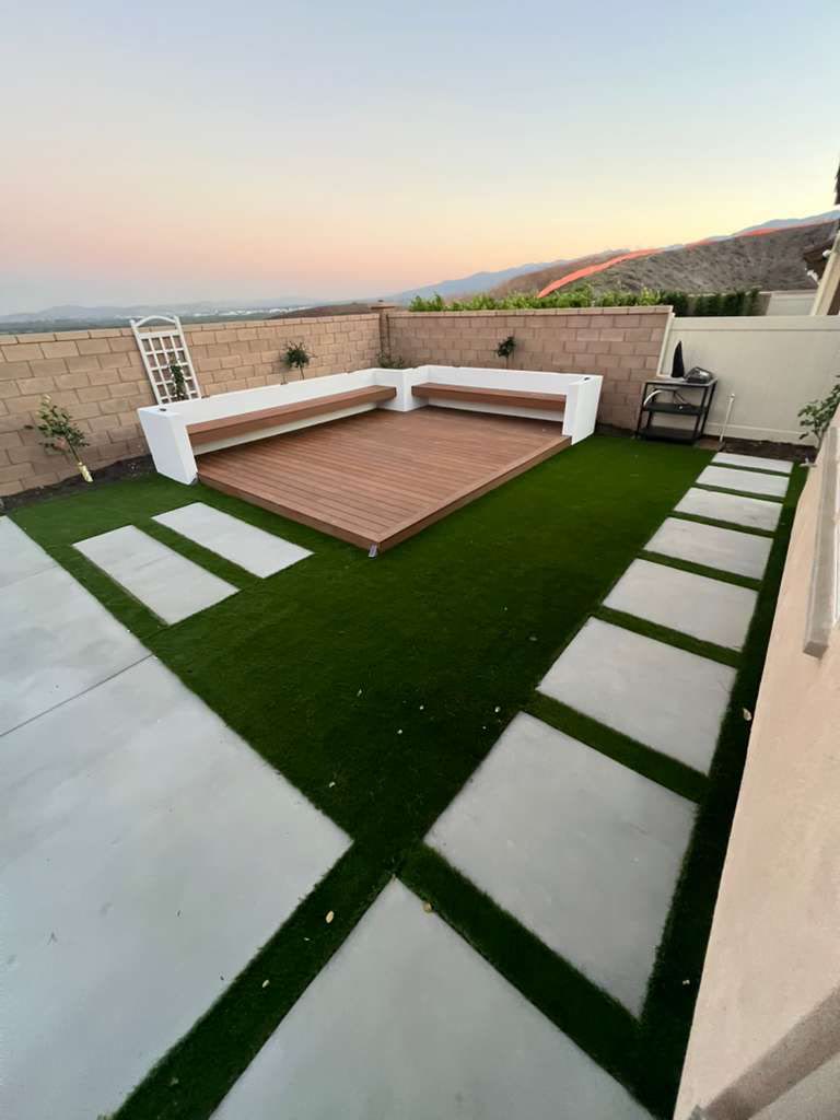 Concrete patio pads and stepping stones with turf joints at sunset