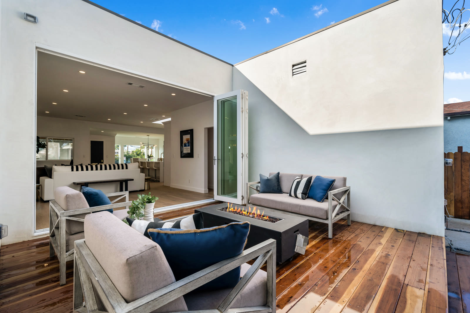 Indoor-outdoor courtyard deck with lounge sofa and fire table