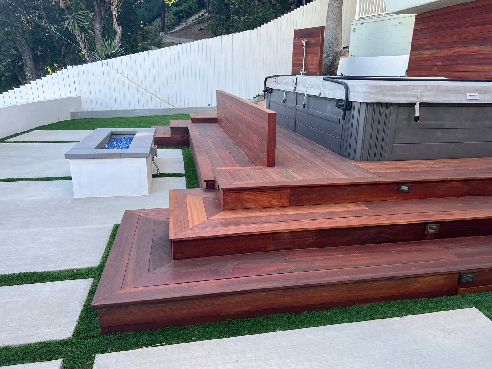 Multi-level mahogany deck with built-in bench, spa, and fire pit