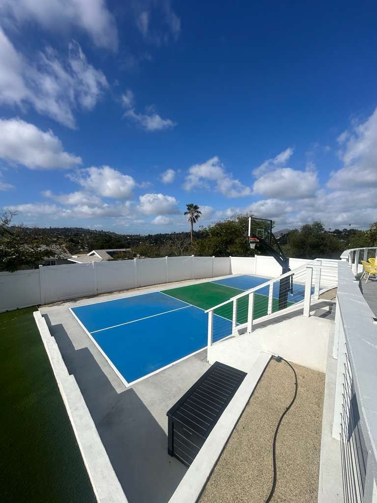 Rooftop blue-and-green sport court with city and canyon views