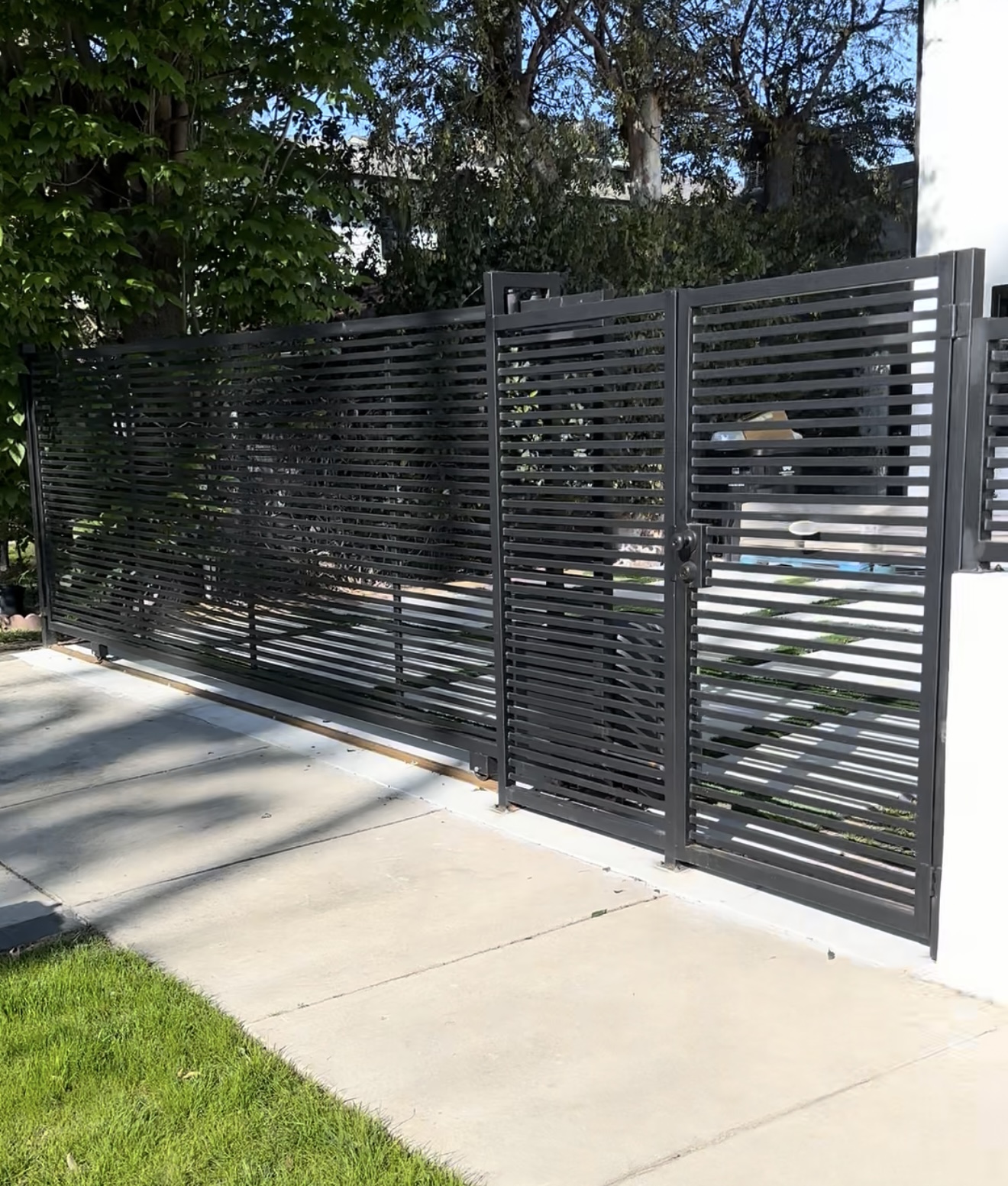 Modern black horizontal-slat driveway gate