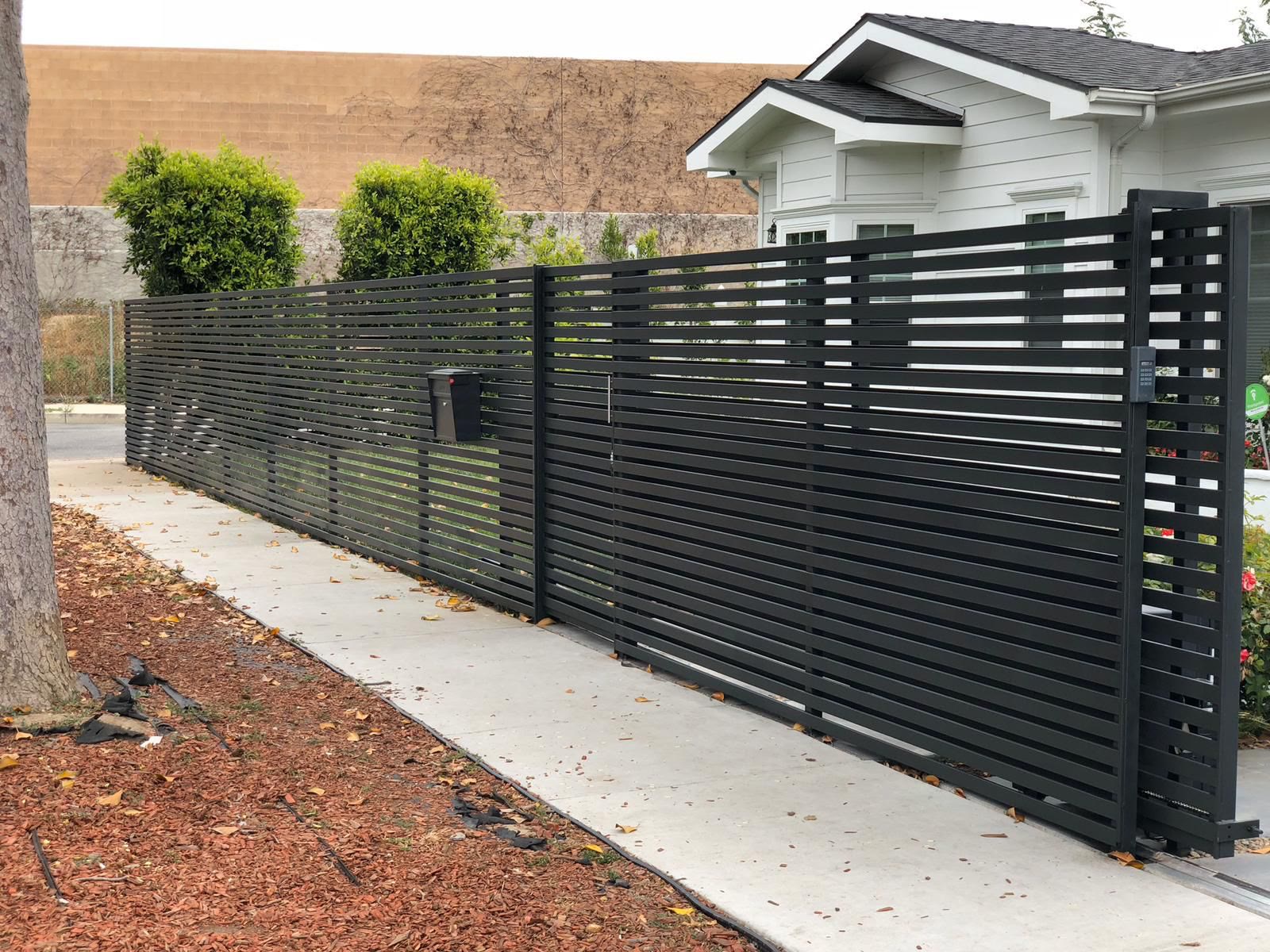 Modern black horizontal-slat fence with matching sliding driveway gate