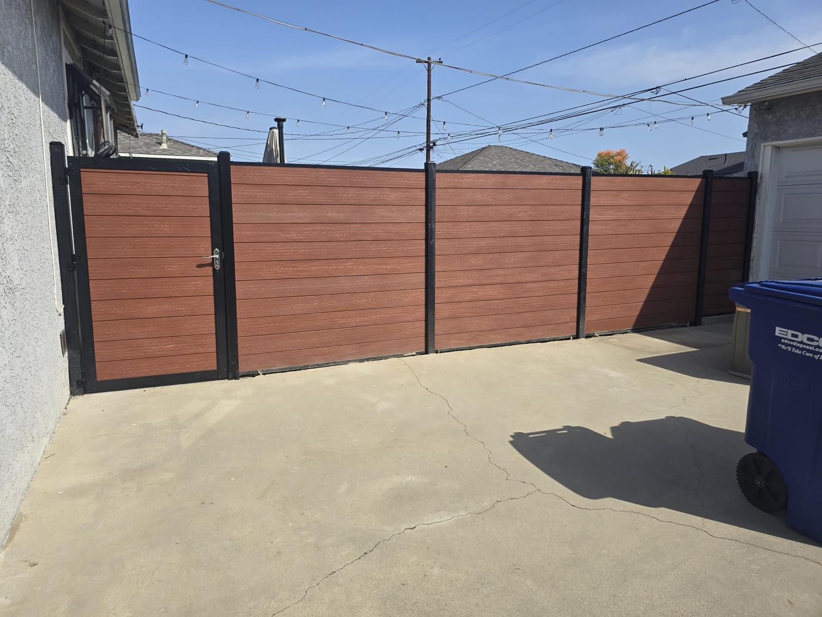 Warm woodgrain composite panels under blue sky