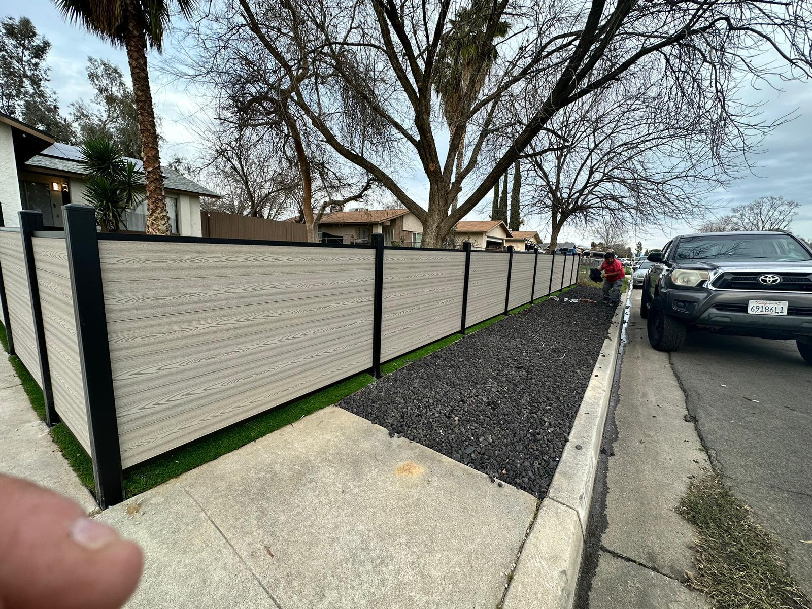 Light composite fence lining a residential street