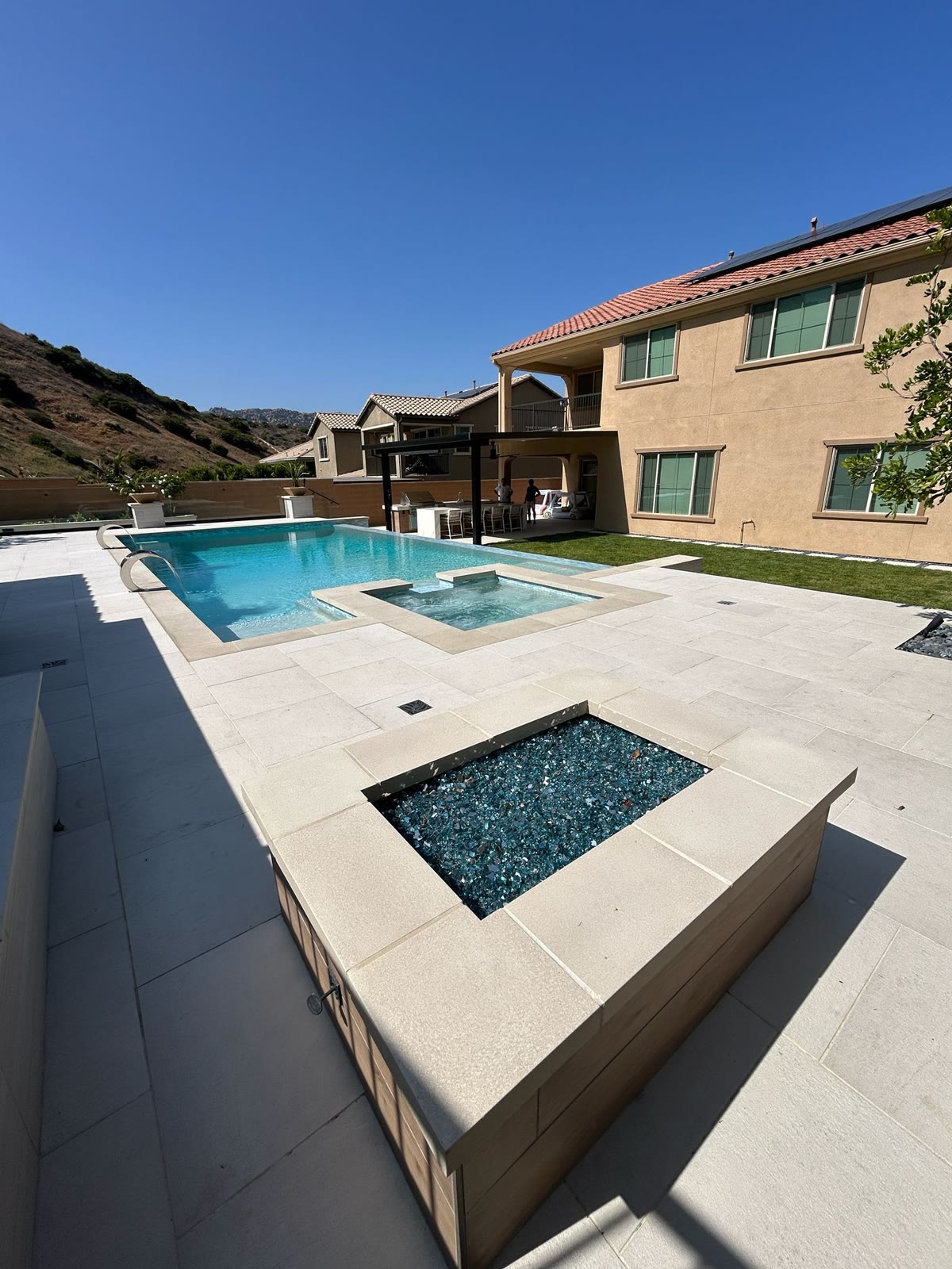 Linear fire pit with long floating bench seating