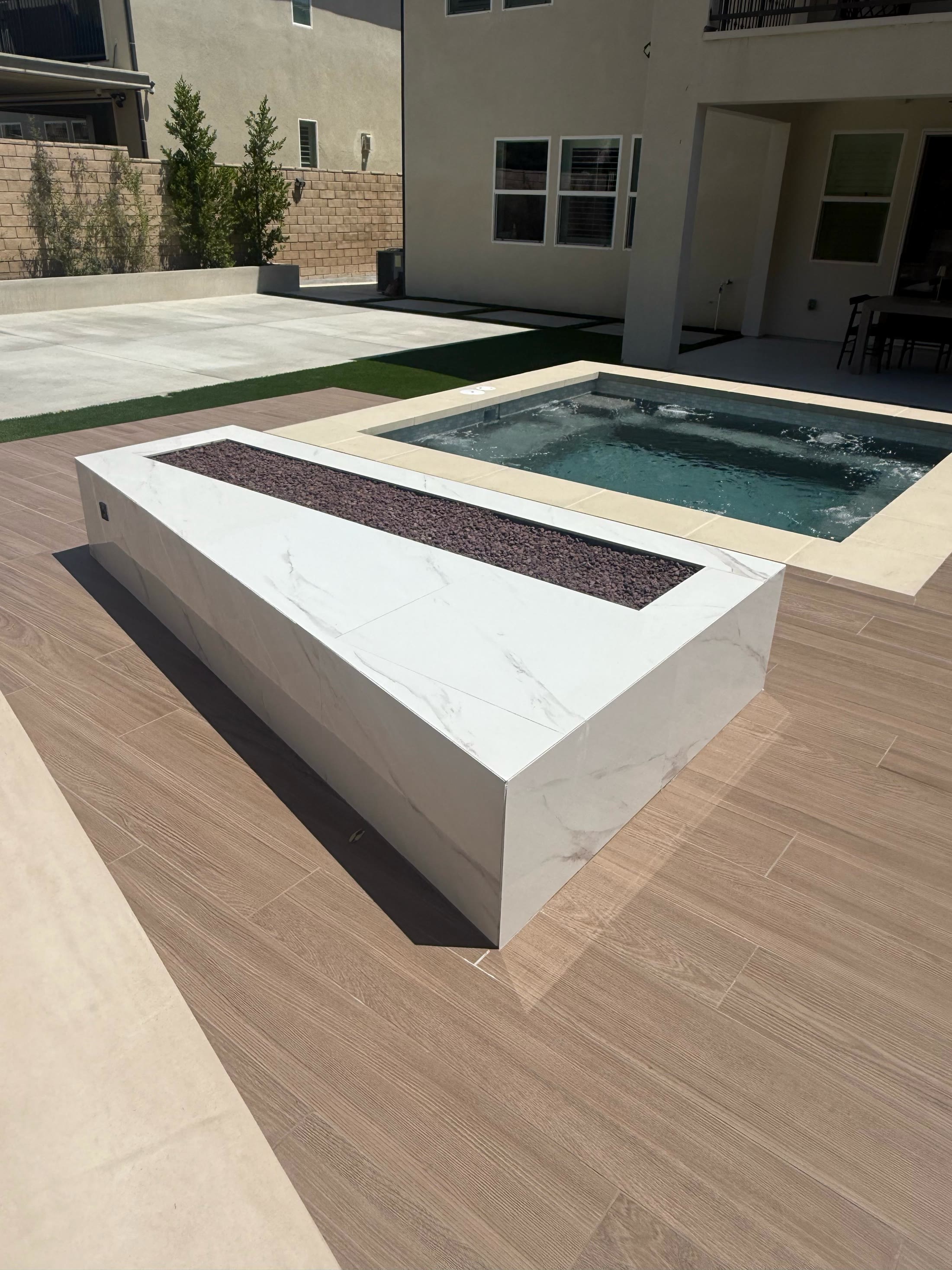 Modern fire feature beside a spa