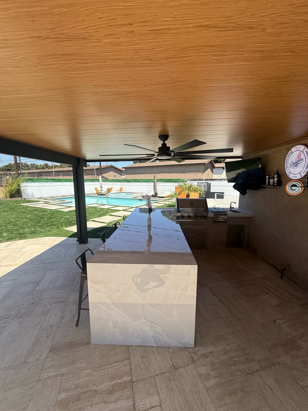 Waterfall-edge marble bar island with poolside view
