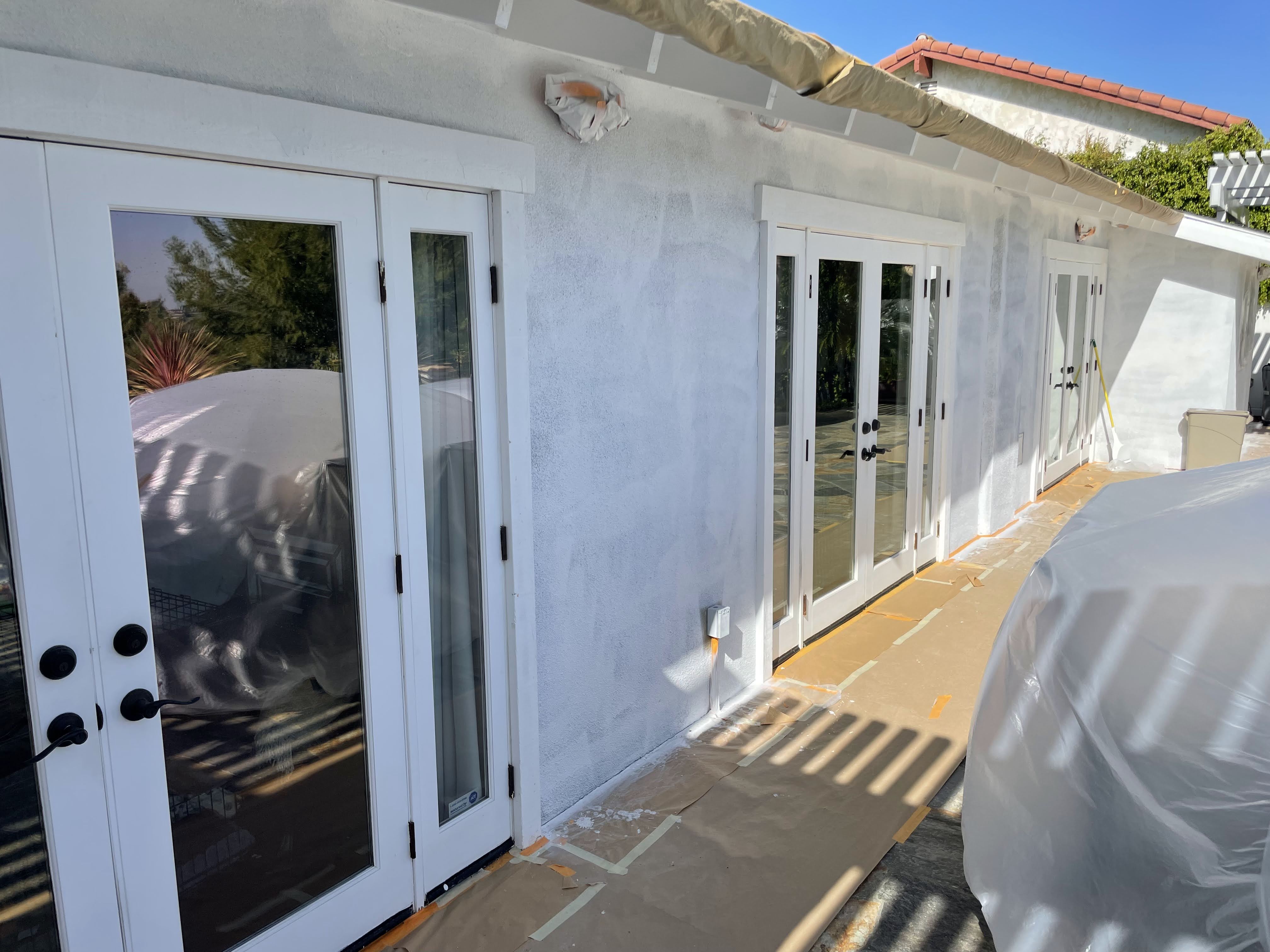 Freshly painted stucco with French doors