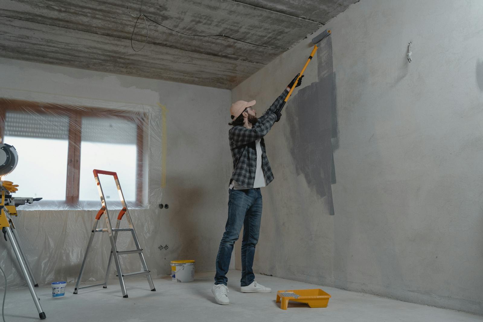 Rolling a fresh coat across an interior wall