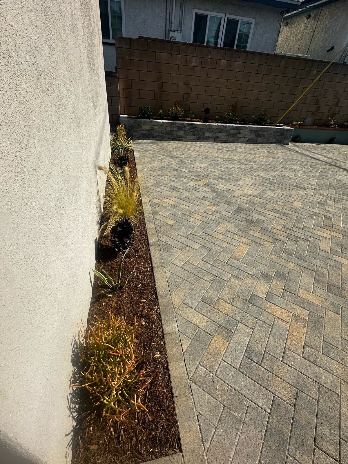 Herringbone paver patio with planter bed