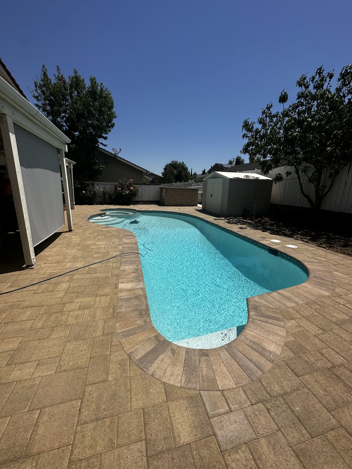 Freeform pool with stamped paver patio