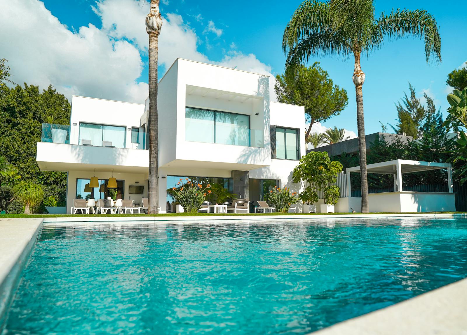 Pool and landscaped garden beside a tiled patio