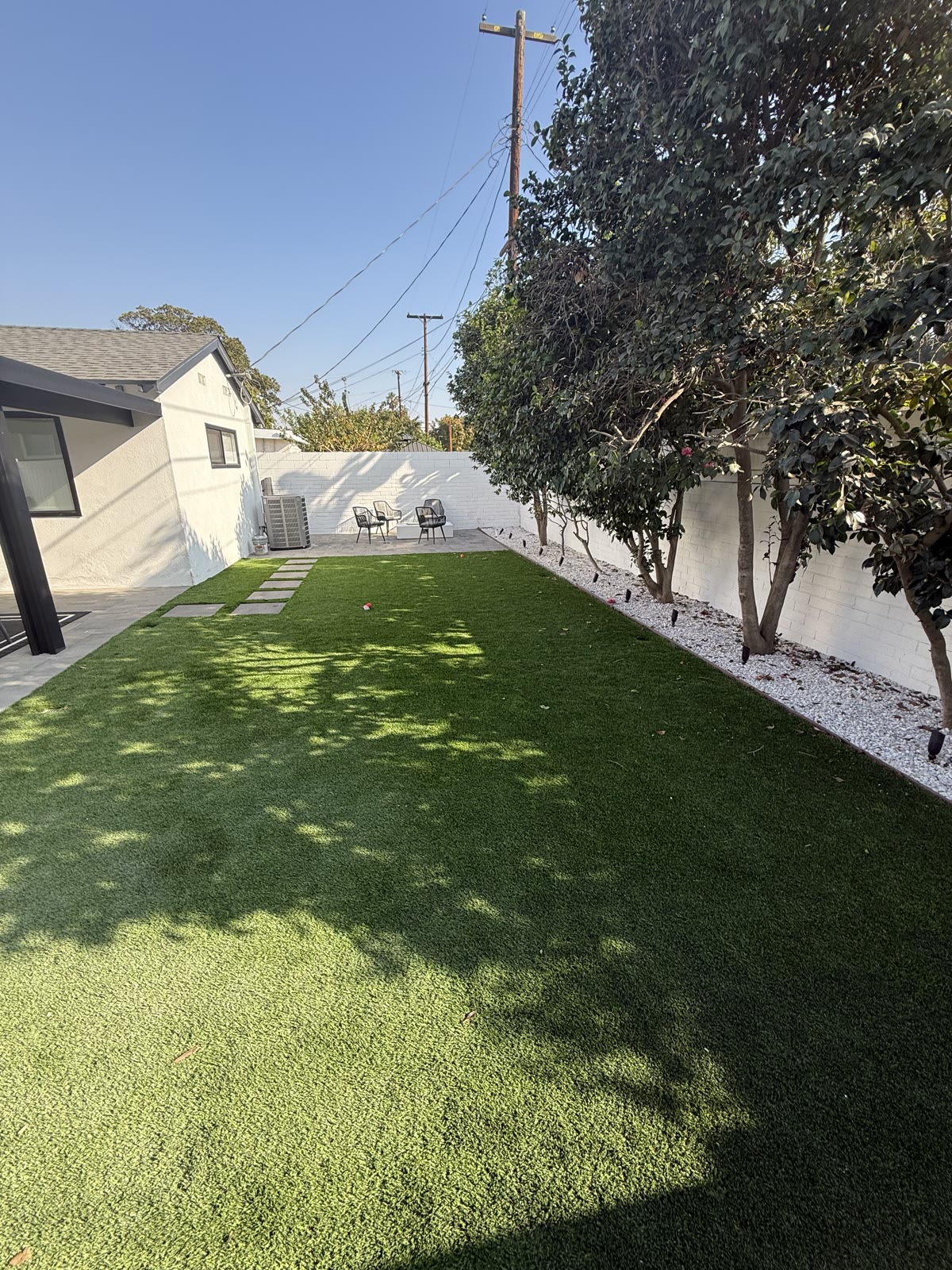 Turf lawn with paver pathway and shade trees